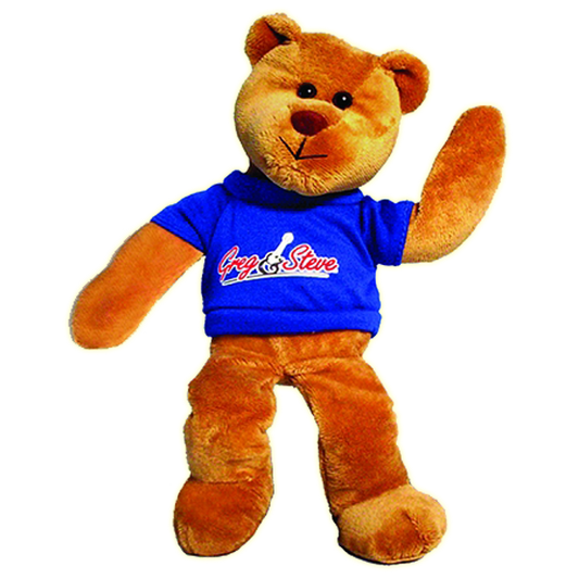 A plush bean bag teddy bear with a blue t-shirt featuring the text 'Greg & Steve'. The teddy bear has a brown color and is posed as if waving.